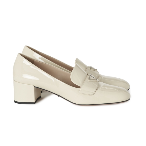 491 - Prada, a pair of patent leather loafers, crafted from cream patent leather, featuring the maker's si... 