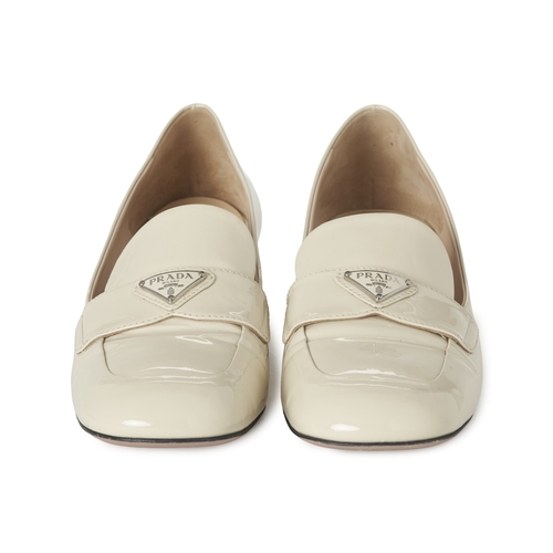 491 - Prada, a pair of patent leather loafers, crafted from cream patent leather, featuring the maker's si... 