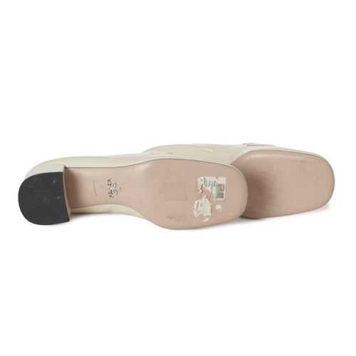 491 - Prada, a pair of patent leather loafers, crafted from cream patent leather, featuring the maker's si... 