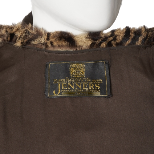 520 - Jenners, a 1950s ocelot fur coat, featuring a lapel collar, hook and eye fastenings, rolled cuffs, t... 