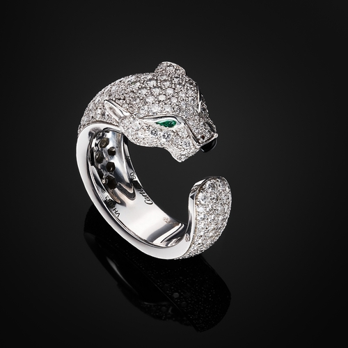 63 - Cartier, an 18ct white gold pave-set diamond Panthere de Cartier ring, medium model, with emerald ey... 