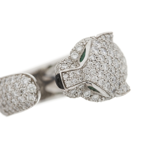 63 - Cartier, an 18ct white gold pave-set diamond Panthere de Cartier ring, medium model, with emerald ey... 