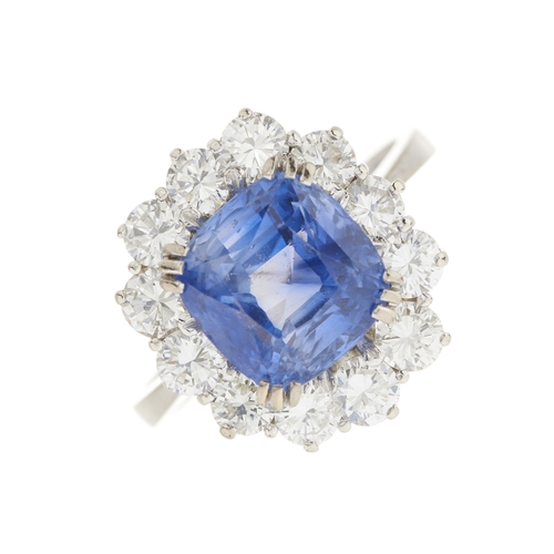 80 - An 18ct gold Sri Lankan sapphire and brilliant-cut diamond cluster ring, with report from WGI statin... 