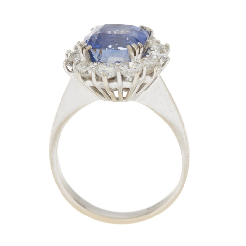 80 - An 18ct gold Sri Lankan sapphire and brilliant-cut diamond cluster ring, with report from WGI statin... 