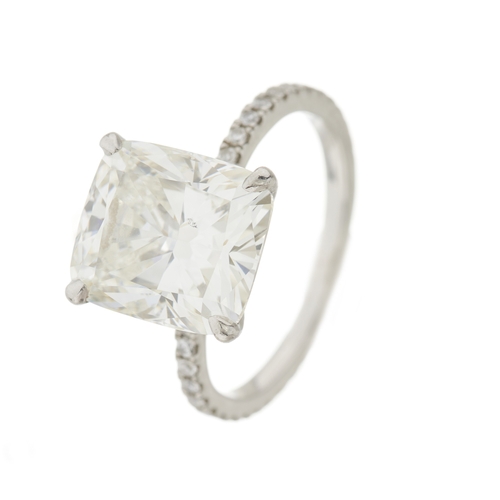 82 - An impressive platinum cushion-shape diamond single-stone ring, with brilliant-cut diamond line shou... 