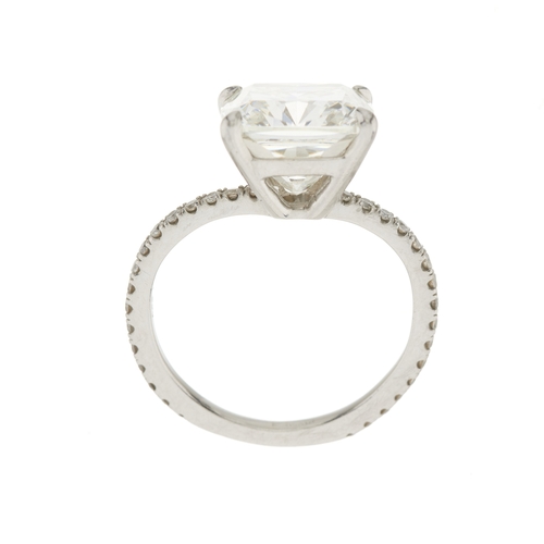 82 - An impressive platinum cushion-shape diamond single-stone ring, with brilliant-cut diamond line shou... 