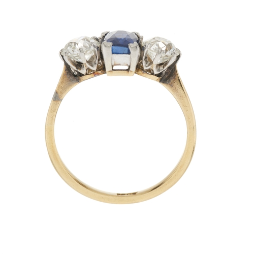 87 - A mid 20th century 18ct gold cushion-shape sapphire and old-cut diamond three-stone ring, estimated ... 