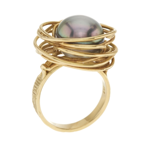 97 - An 18ct gold grey cultured pearl dress ring, with stylised bird's nest wire surround and textured ba... 