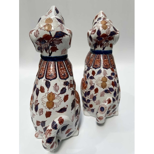115 - A pair of decorative Imari-patterned chimney dogs, 35cm high (2)