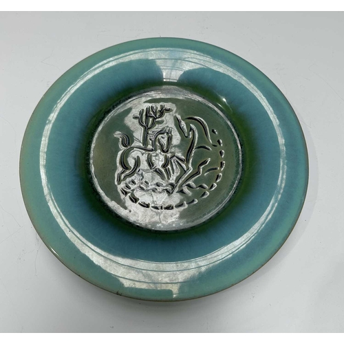 117 - United States Quarry Tile Company, a Romany art pottery sgraffito decorated plate, incised with a st... 