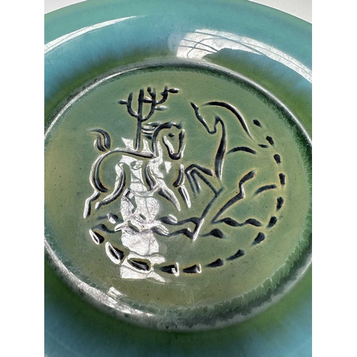 117 - United States Quarry Tile Company, a Romany art pottery sgraffito decorated plate, incised with a st... 