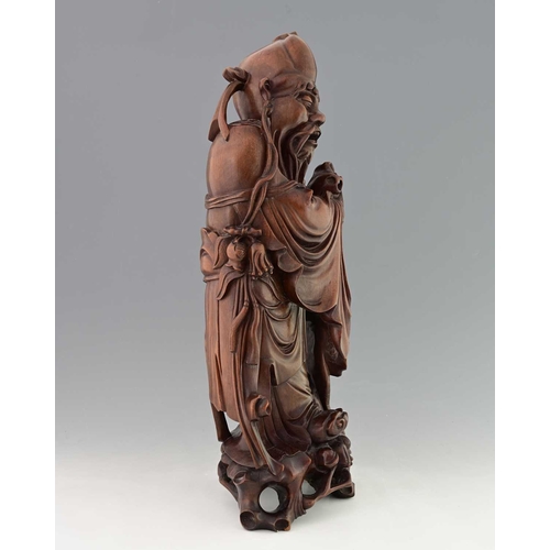 118 - A large Chinese carved hardwood figure of Shouxing, modelled in high relief holding a peach and staf... 