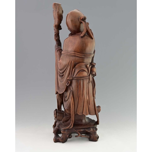 118 - A large Chinese carved hardwood figure of Shouxing, modelled in high relief holding a peach and staf... 