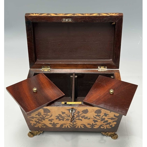 129 - A Regency Inlaid tea caddy of sarcophagus form with marquetry work to the front and top, mounted on ... 