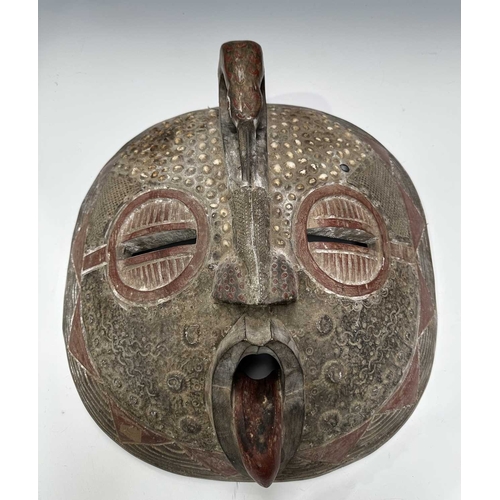133 - An African tribal mask, probably from the Ashanti (Asante) people of Ghana, a large round face carve... 