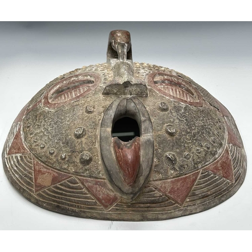 133 - An African tribal mask, probably from the Ashanti (Asante) people of Ghana, a large round face carve... 