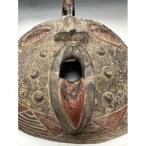 133 - An African tribal mask, probably from the Ashanti (Asante) people of Ghana, a large round face carve... 
