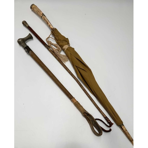 134 - A late 19th early 20th century ladies parasol, carved horn handle and tip, cane shaft with white met... 