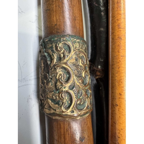 137 - Five walking sticks, hazel and bamboo shafts, one with yellow metal cuff, 88cm long and a swagger st... 