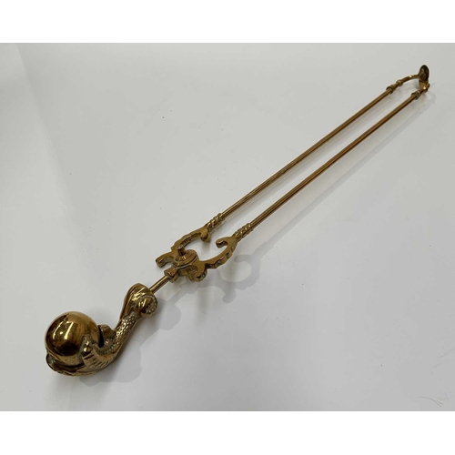 143 - A brass companion set and fire dogs, the poker, tongs and shovel all with clawed bird feet holding b... 