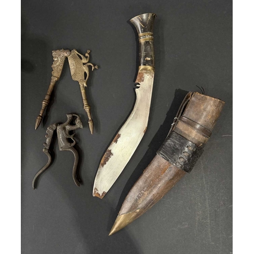 149 - Brass mounted Kukri knife in sheath, 42cm long, together with two zoomporphic cast metal nutcrackers... 