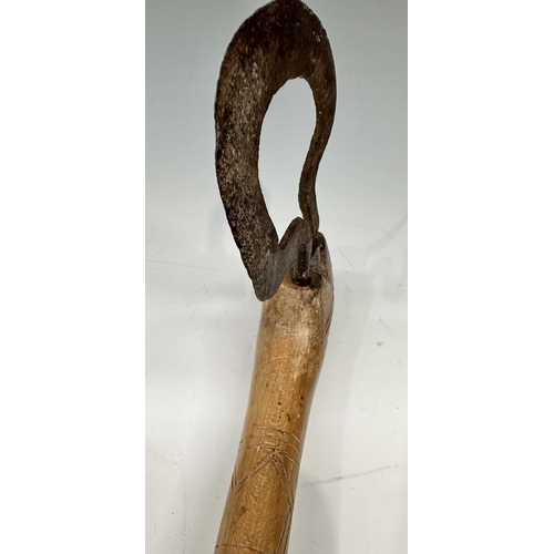 153 - A tribal club or axe, likely a West African Fon Ceremonial Axe, the wooden handle with scratch carvi... 