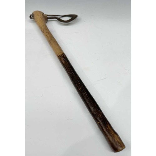 153 - A tribal club or axe, likely a West African Fon Ceremonial Axe, the wooden handle with scratch carvi... 