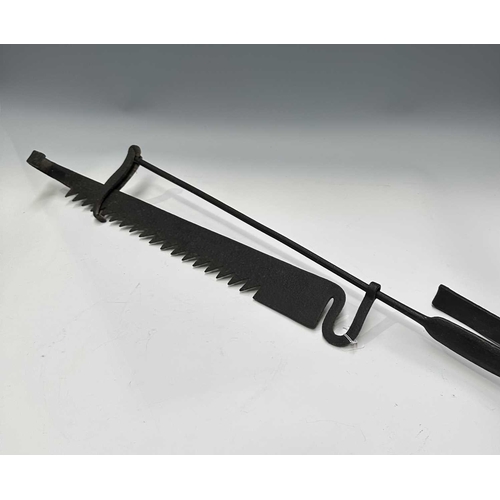 154 - A cast iron butchers hook or steelyard balance scale, length 67cm, together with a wrought iron tram... 