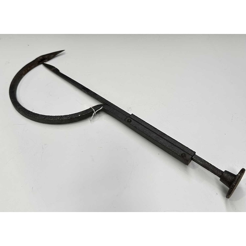 154 - A cast iron butchers hook or steelyard balance scale, length 67cm, together with a wrought iron tram... 