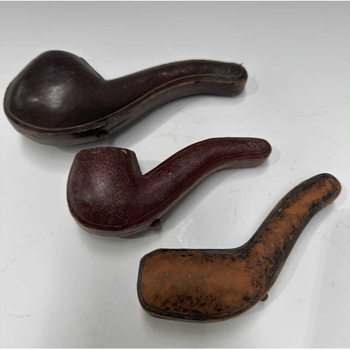 160A - Three Meerschaum pipes, early 20th Century, one a bird of prey talon, one a hand, one bud-shaped, al... 