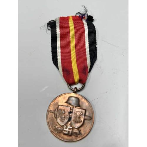 166 - A collection of militaria to include a Third Reich, Second Class Iron Cross on ribbon; a World War I... 