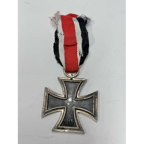 166 - A collection of militaria to include a Third Reich, Second Class Iron Cross on ribbon; a World War I... 
