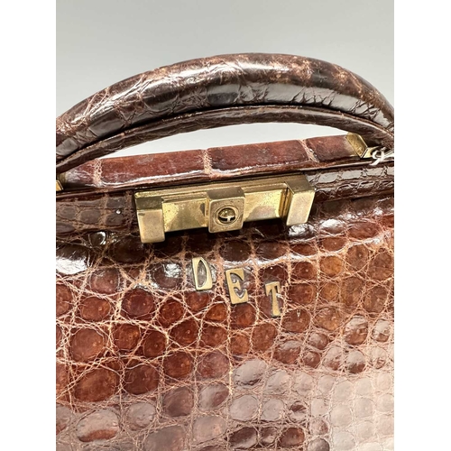 172 - A vintage crocodile Gladstone bag w/ matching purse, featuring gold-tone hardware including the init... 
