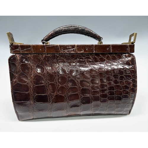 172 - A vintage crocodile Gladstone bag w/ matching purse, featuring gold-tone hardware including the init... 