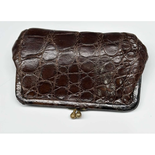 172 - A vintage crocodile Gladstone bag w/ matching purse, featuring gold-tone hardware including the init... 