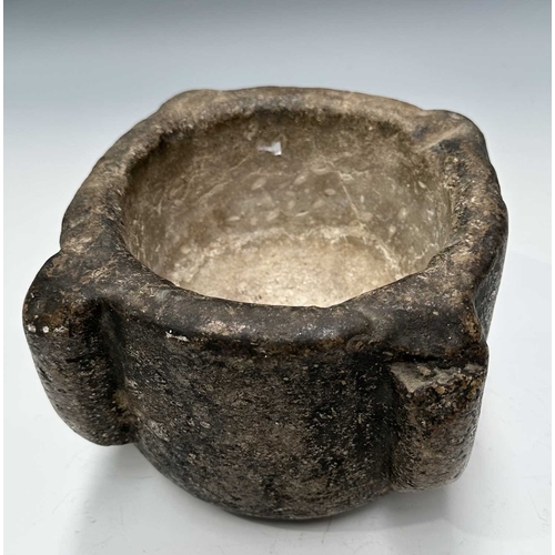 176 - A stone mortar, carved from limestone, possibly Purbeck marble and possibly Middle Ages, four lugs, ... 