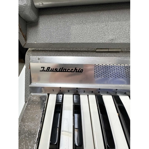 188 - A 'Busilacchio' cased electric organ with screw in legs, l: 67.5cm. h: 21cm, d: 29cm