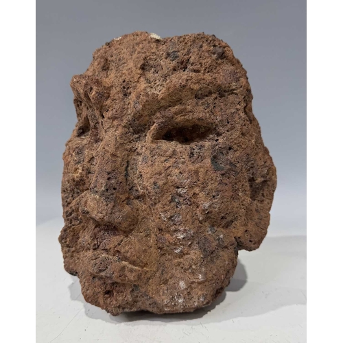 207 - A red volcanic stone mask, carved in the 'primitivist' style, 24cm long, with stand Provenance: salv... 