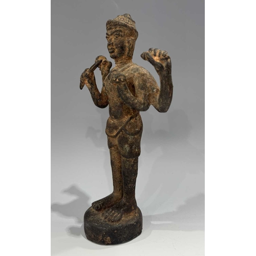 213 - A Khmer type bronze figure of a four-armed Vishnu, 19th century or earlier, standing atop a circular... 