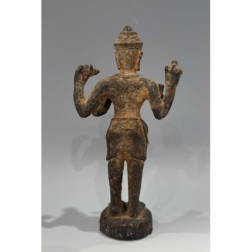 213 - A Khmer type bronze figure of a four-armed Vishnu, 19th century or earlier, standing atop a circular... 