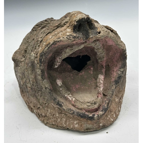 225 - A tiger mask modelled with fierce staring eyes and open jaw, clay body with painted surface moulding... 