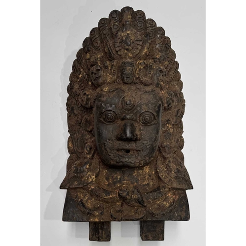 232 - A wooden shrine bust mask of Bhairava, Kathmandu valley, 18th century or earlier, ornately carved wi... 
