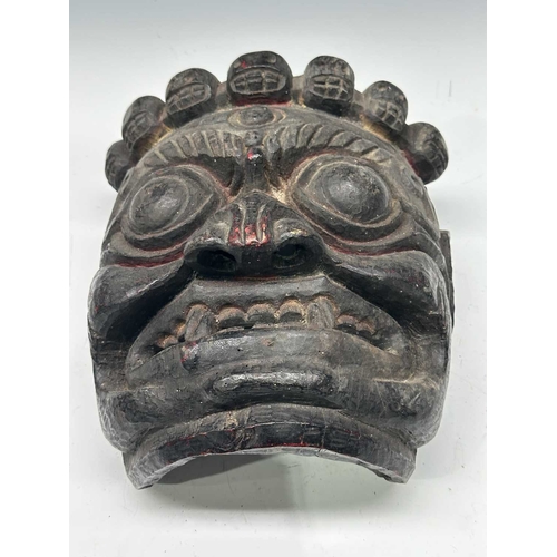 240 - A carved hardwood Lamaist dancer's mask, Mahaka-type iconographic form, Tibet, late 18th/early 19th ... 