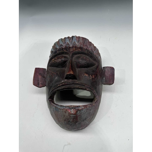 244 - A carved and painted wood dancer's mask, Terai region, Nepal, c.1900, modelled with pointed crown an... 
