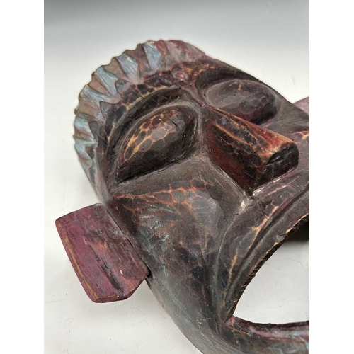 244 - A carved and painted wood dancer's mask, Terai region, Nepal, c.1900, modelled with pointed crown an... 