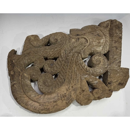 248 - An intricate relief hardwood panel, carved on both sides, modelled as a tiger breathing fire, 19th c... 