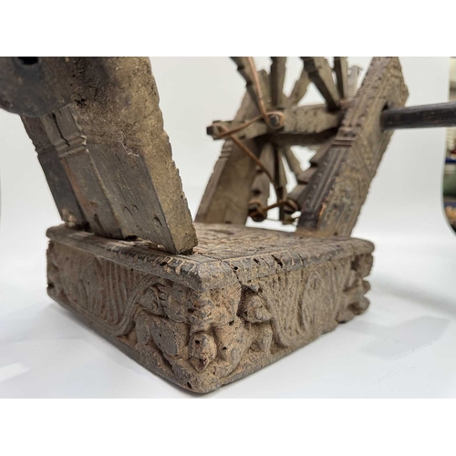 250 - A Himalayan cotton spinning wheel or charkha, 19th century or earlier, richly decorated, the top car... 