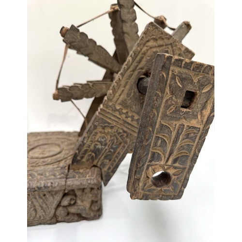 250 - A Himalayan cotton spinning wheel or charkha, 19th century or earlier, richly decorated, the top car... 