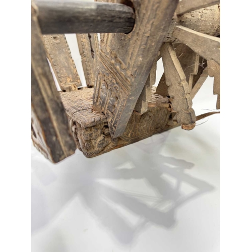 250 - A Himalayan cotton spinning wheel or charkha, 19th century or earlier, richly decorated, the top car... 