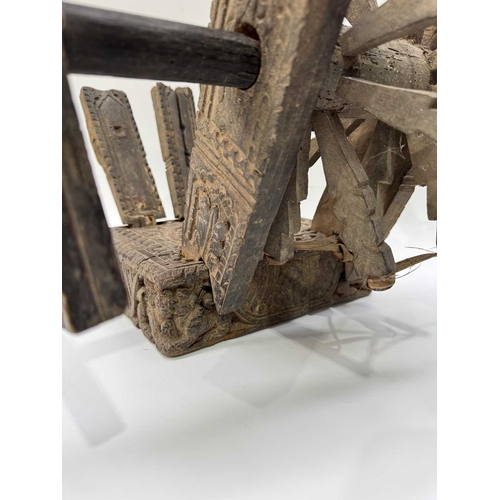 250 - A Himalayan cotton spinning wheel or charkha, 19th century or earlier, richly decorated, the top car... 